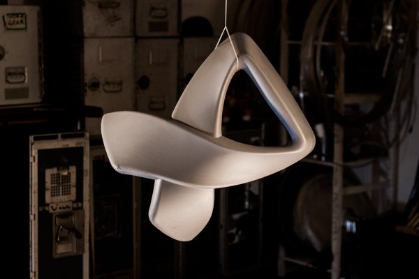 A white Ribbon stool hanging in mid-air