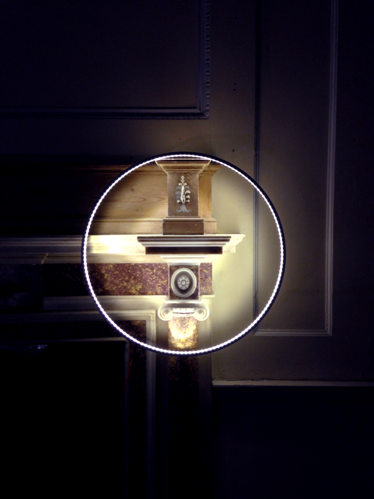 A Hoop light, hanging from the side of a marble and wood mantlepiece, it just makes everything look so cool and spooky.