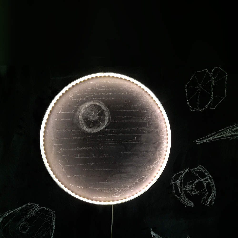 A Hoop light, placed on a chalk drawing of the Death Star - featured in the film Star Wars - brings life to the image, adding depth and texture to the image. 