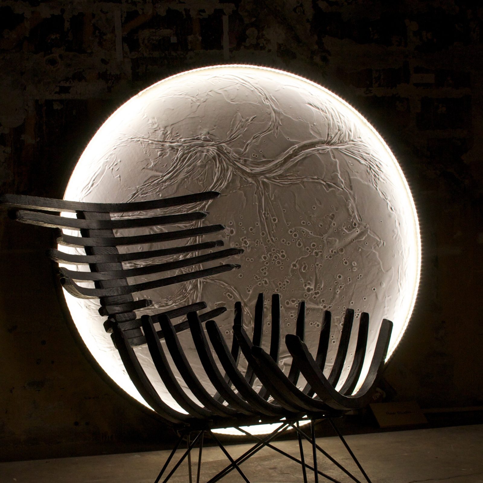 luna light hanging behind carbon chair